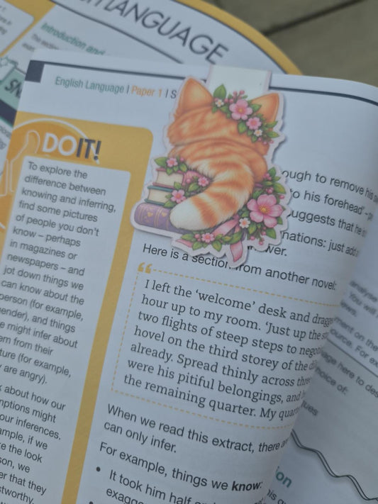 Back view of handmade floral cat magnetic bookmark clipped over a book page