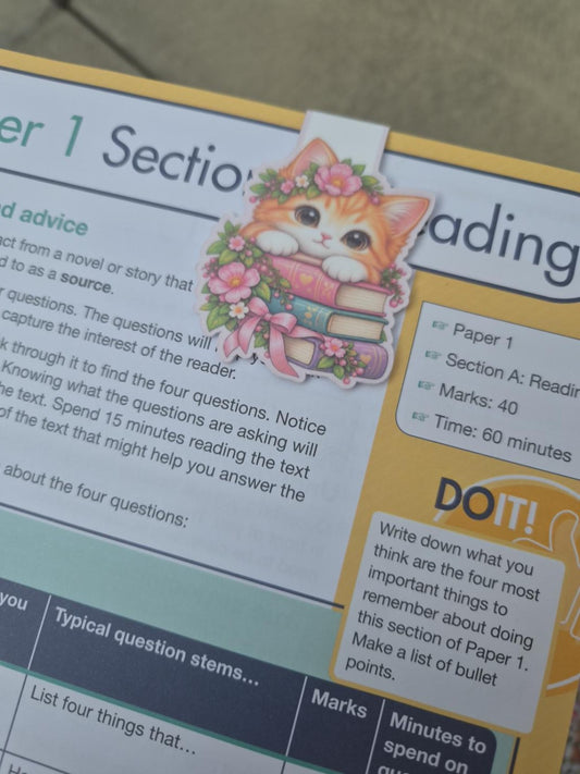 Handmade floral cat magnetic bookmark clipped over a book page