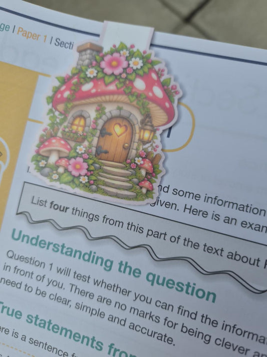 Reverse design of whimsical pink mushroom house magnetic bookmark with flowers